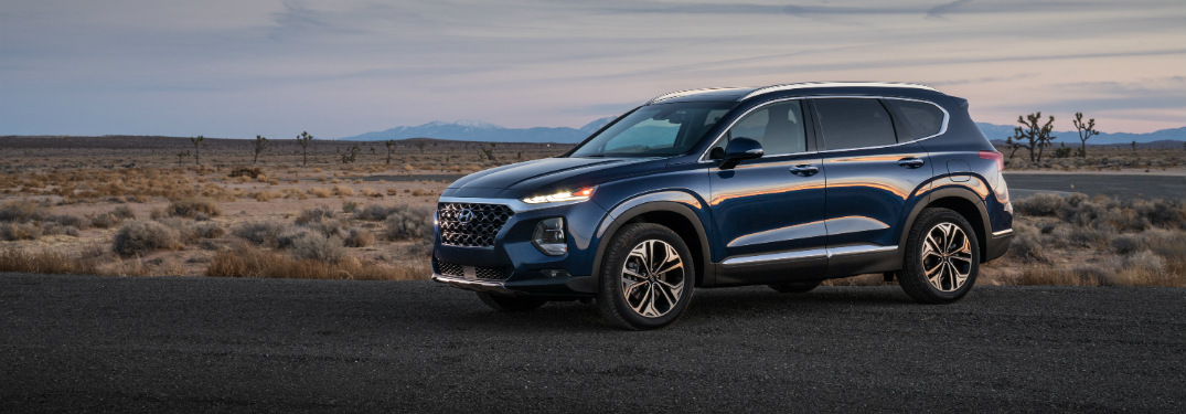 side view of blue 2019 santa fe in empty field