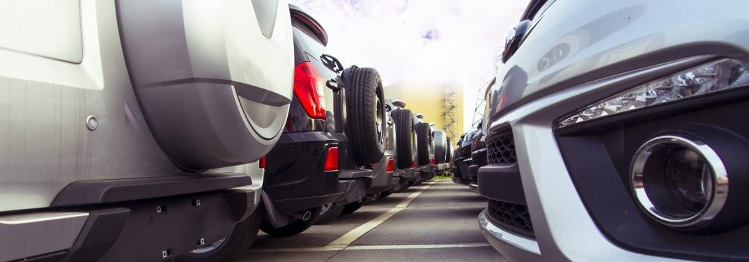 A row of new cars parked at a car dealer shop