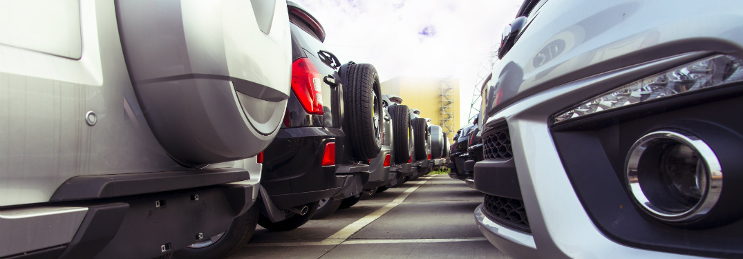 rows of different rear and front bumpers of cars in car lot