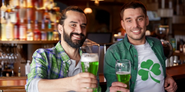 Men holding green beers
