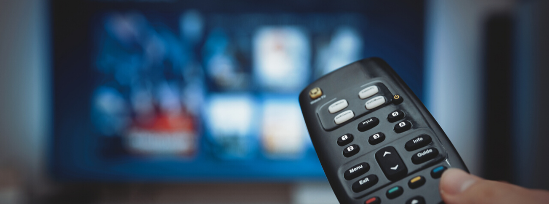 Closeup of remote pointing at TV