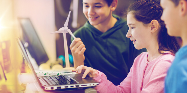 Three kids in front of computer