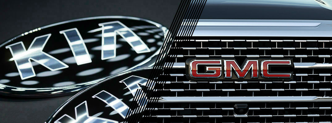 Closeup of Kia logo and GMC logo