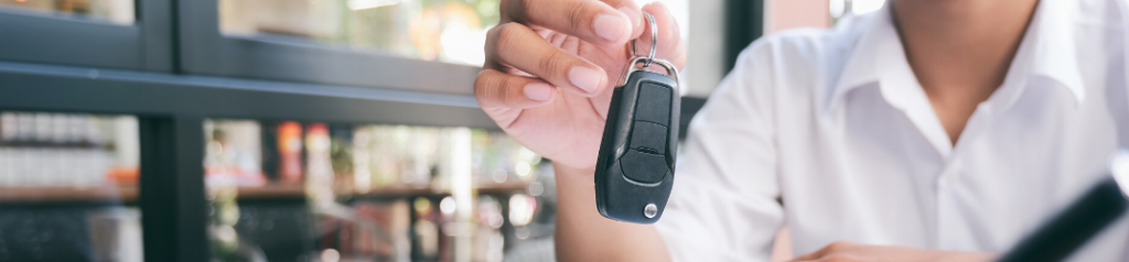 Hands holding out keys