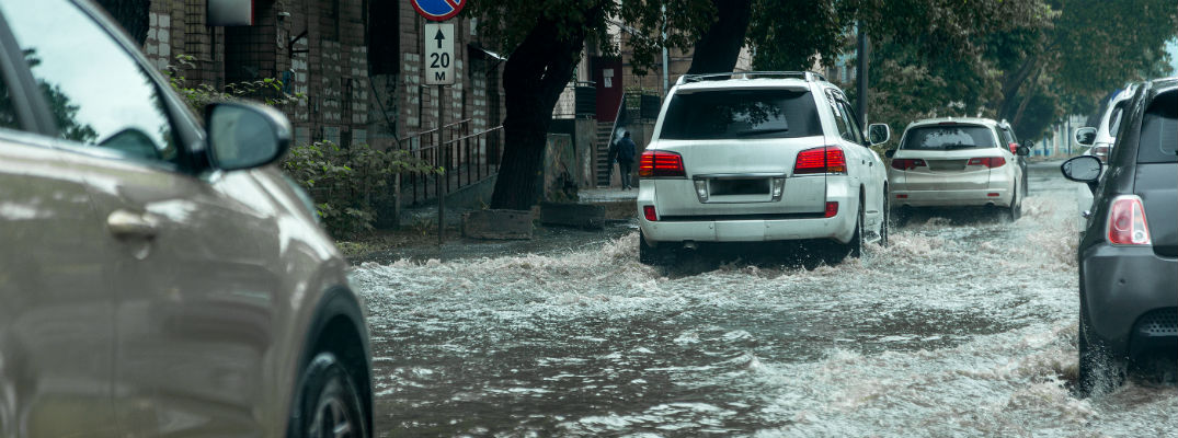 Vehicles driving through flooded road
