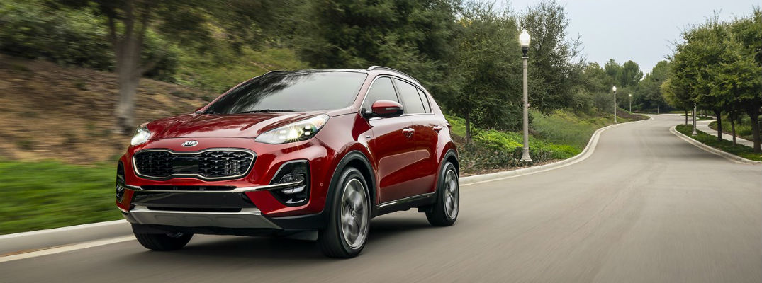 Red 2021 Kia Sportage driving