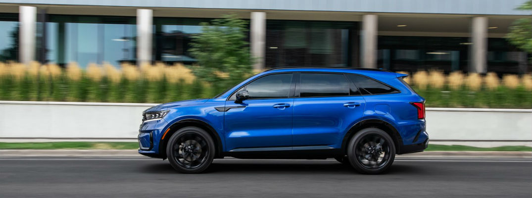 Profile view of blue 2021 Kia Sorento driving