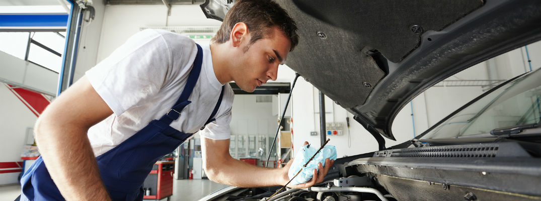 Mechanic working under vehicle hood