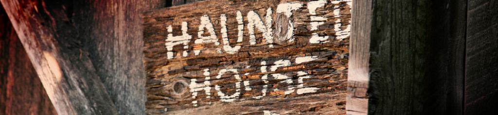 Closeup of wooden haunted house sign