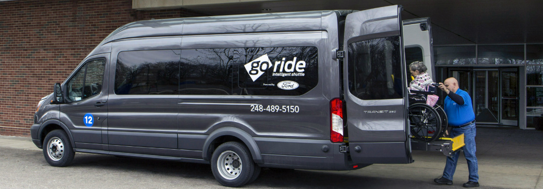Driver Loading a Woman in Wheel Chair into a Ford GoRide Van