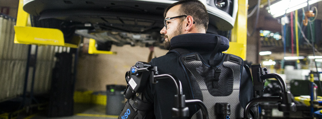 Ford Worker Assembling a Ford Mustang with the EksoVest
