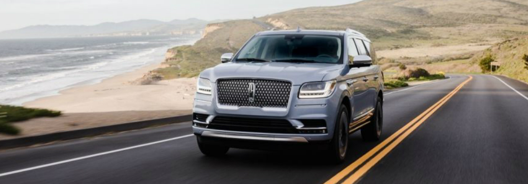 Silver 2018 Lincoln Navigator Driving on a Coastal Road