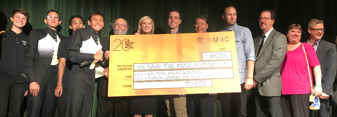 People Holding a Giant Check from Toyota to VH1 Save the Music
