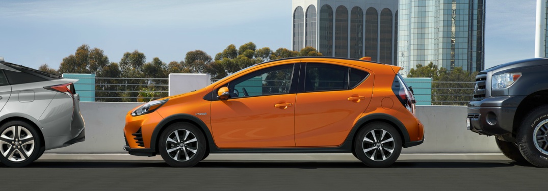 orange 2018 Toyota Prius c side view
