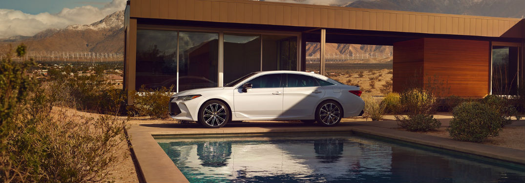 2019 Toyota Avalon exterior drivers side profile in front of large building