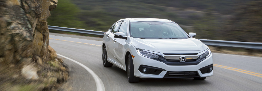 2018 Honda Civic Sedan in white rounding a mountain corner