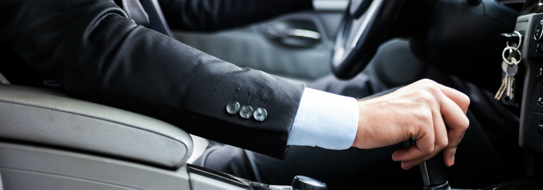 Man driving a car with manual transmission