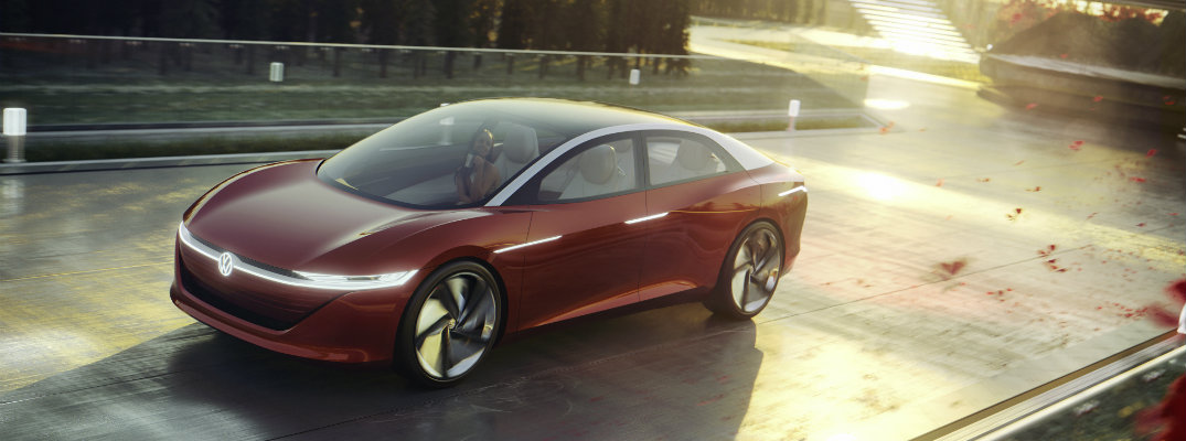 2018 VW I.D. Vizzion electric concept sedan driving on private home road with fall sunset