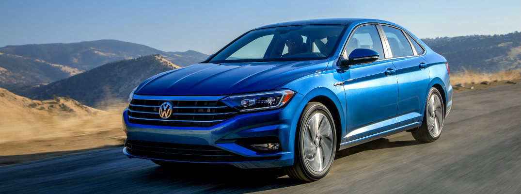 2019 Volkswagen Jetta driving through the desert wilderness on an empty highway