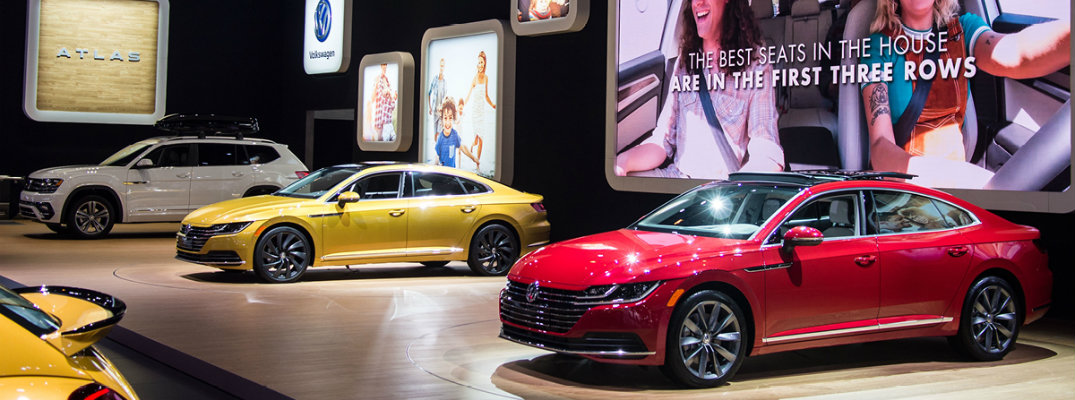 Volkswagen Auto Show experience display of the 2019 Arteon, 2018 Atlas, 2018 Beetle and more on platforms next to screen demonstrations