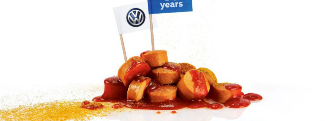 Volkswagen sausage seasoned with spice and dipped in ketched with VW and 45 years flag planted