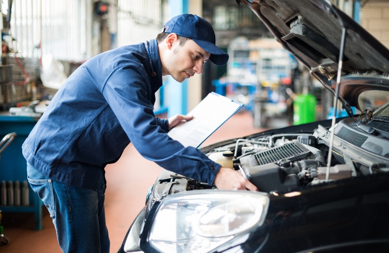 Mechanic working under the hood of a vehicle