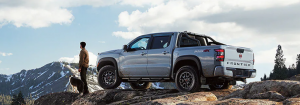 2024 Nissan Frontier back view and a man standing near it