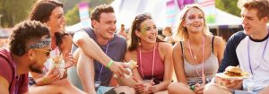 Group of friends sitting down at a festival