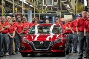 Nissan workers next to the 2019 Nissan Altima