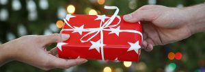 people giving a red gift