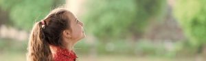 girl looking up and smiling