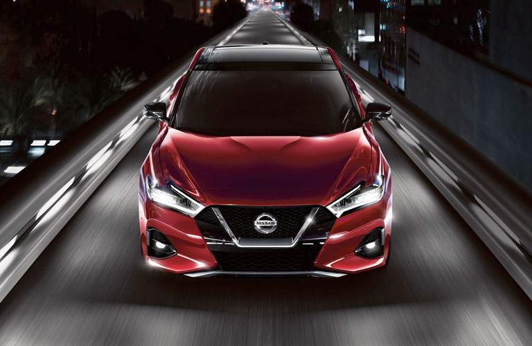 red 2020 Nissan Maxima driving on a bridge