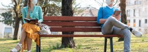man and woman social distancing in a park