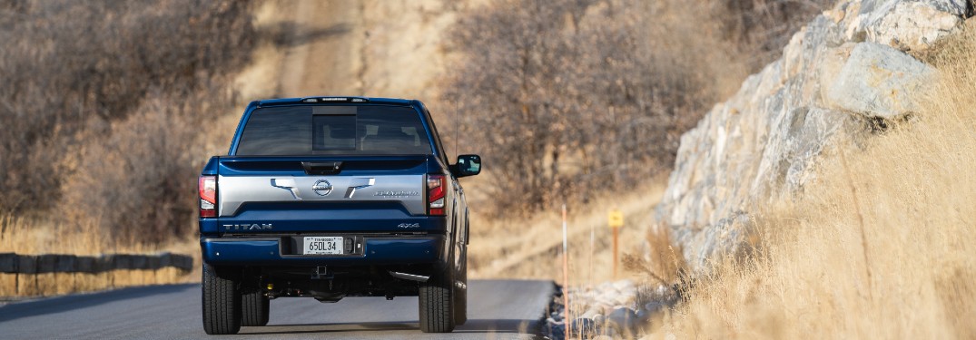 rear view of the 2021 Nissan TITAN driving through desert