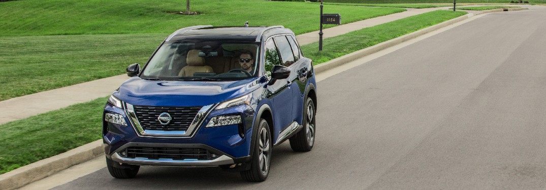 2021 Nissan Rogue driving through neighborhood