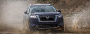 2022 Nissan Pathfinder blue front view in mud