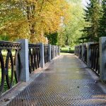 A-bridge-in-a-park-surrounded-by-tall-trees_b