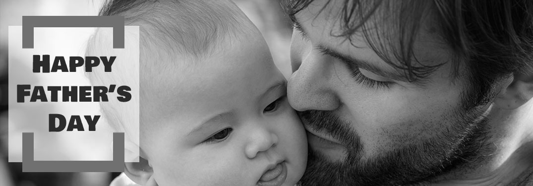 Black and White Photo of Dad Kissing His Son with Black Happy Father's Day Text