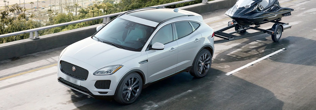 2020 Jaguar E-PACE pulling a jet ski down the road