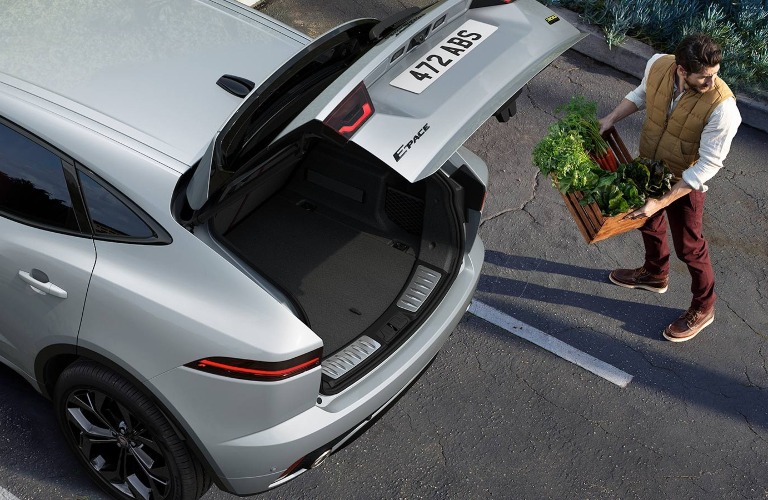 Man loading up the back end of the 2021 Jaguar E-PACE