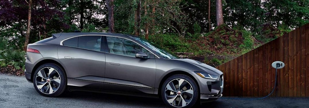 2021 Jaguar I-PACE charging in a tree covered road