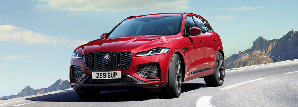 Red 2022 JAGUAR F-PACE cruising through the road