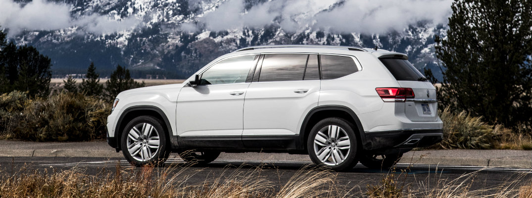 2018 Volkswagen Atlas white parked in wilderness with a snowy mountain in the background