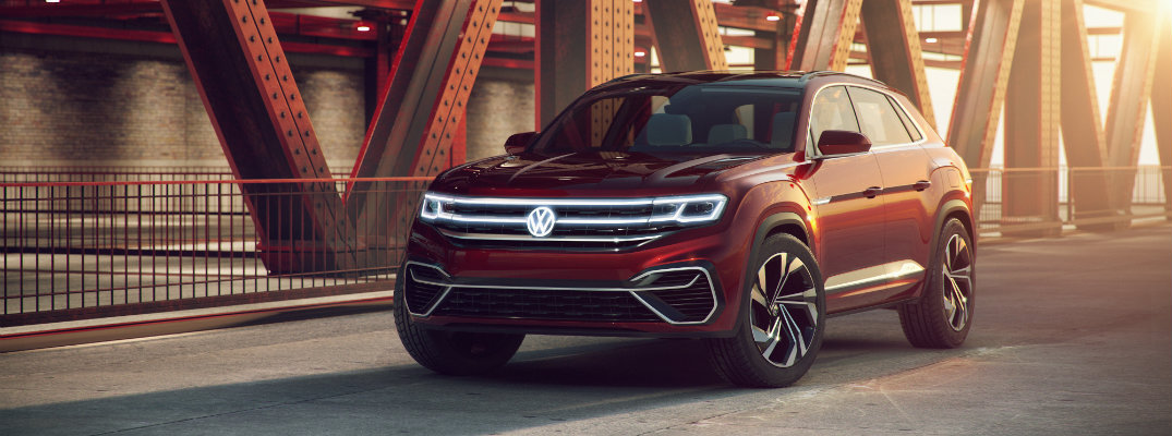 vw atlas cross sport suv concept hybrid front exterior shot parked on a sunrise bridge with bright shadows