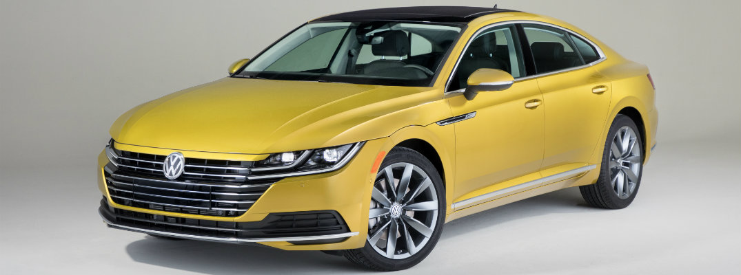 2019 Volkswagen Arteon exterior shot with yellow paint job in an empty showcase room