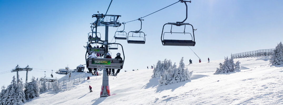 Ski lift carrying people up a mountain
