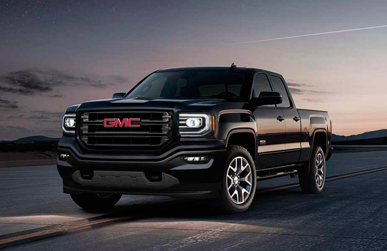 2017 GMC Sierra driving on highway at night