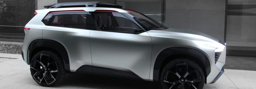 Side profile of the Nissan Xmotion concept vehicle outside of a gray concrete building