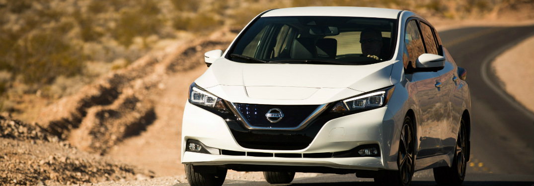 white 2018 nissan leaf driving on desert highway