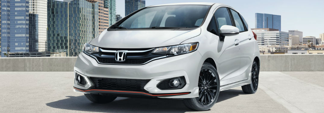 2019 Honda Fit Pricing and Features with image of 2019 Honda Fit in Platinum Pearl White parked on roof of a parking garage with view of a city in the background